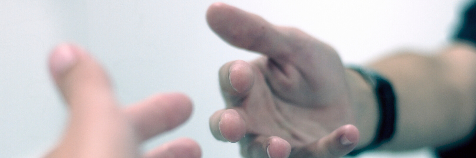 Kvinna med hästsvans står med ryggen vänd och tittar mot skogsglänta.